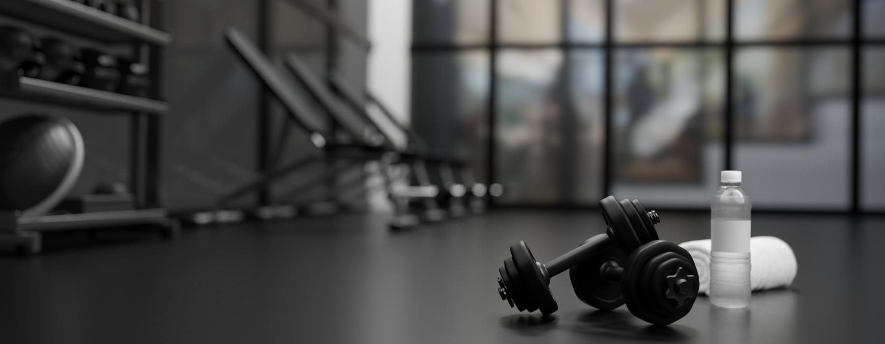 dumbbells water and a towel on the ground
